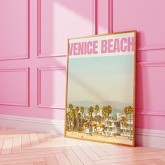 a pink room with a poster on the wall that says venice beach in front of it