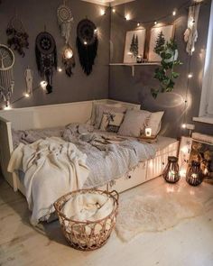 a bedroom with lights strung from the ceiling and decorations on the wall, along with a bed