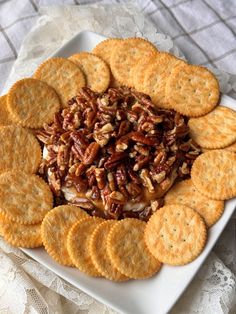 a white plate topped with crackers and nuts