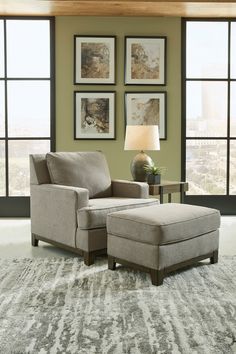 a living room with a chair and ottoman