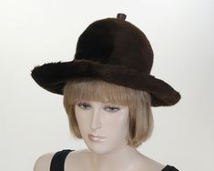 Unique brown winter hat from Germany.  The fabric is very soft and similar to felt in texture.  There is the word "Qualitatser Zeuguis Fur" stamped on the inside but I'm not sure what that really means.  It's not a fur as I know it.  Plus there is a leather button on the top.  Wear the wide brim up or down.  Just something different.  Make a fashion statement in the cooler temperatures.  Purchased from an estate. Labels:  E. Deininger - Karlsrume           Year 1970's Condition: Good vintage con Aviator Hat, Vintage Gloves, I Know It, Winter Hat, Wide Brimmed, Leather Top, Fashion Statement, Accessories Hats, Winter Hats