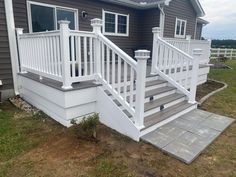 a white porch with steps leading up to it