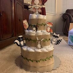 a diaper cake made out of burlocks and stuffed animals on it's sides