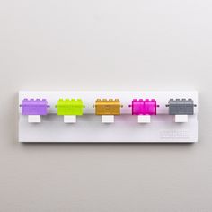 a row of legos on a white wall mounted to the side of a wall