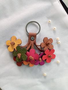 an octopus keychain made out of felt and buttons with flowers on the front