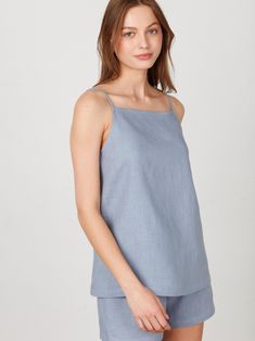 "AMBER is a simple linen strap top with a square neckline. DETAILS - Sleeveless design - Spaghetti straps - Square neckline - Oeko-Tex certified 100% local washed midweight linen - Cut and sewn to order just for you in our studio COLOR - Vista Blue, you can also choose other colors above - Fabric samples are available here https://www.etsy.com/listing/586569696/linen-fabric-samples SIZING & FIT - True to size - Model is 5'10\" / 178cm and wearing a size XS CARE FOR LINEN - Machine wash up to 30ºC/86ºF gentle cycle - Lay flat to dry or tumble dry low - Warm iron if needed - Do not bleach SIZE GUIDE Size conversion guide Size XS (US 0-2, IT 36-38, UK 4-6, Japan 3-5, France 32-34) Size S (US 4-6, IT 40-42, UK 8-10, Japan 7-9, France 36-38) Size M (US 8-10, IT 44-46, UK 12-14, Japan 11-13, Fra Summer Cotton Tops With Straight Neckline, Summer Square Neck Top With Adjustable Straps, Cotton Tops With Straight Neckline For Summer, Spring Square Neck Camisole For Everyday, Spring Everyday Camisole With Square Neck, Spring Everyday Square Neck Camisole, Summer Linen Top With Tie Straps, Summer Cotton Camisole With Square Neck, Square Neck Cotton Camisole For Summer