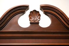 an ornate wooden headboard with carved details