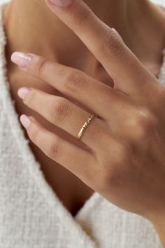 a woman's hand with a gold ring on it