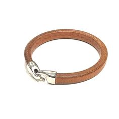 "This cool brown licorice leather bracelet goes once around the wrist and is stiff like a bangle The large rectangular shaped \"licorice\" leather cord is rustic with an engraved pattern on it. it is finished with a silver plated hook clasp Licorice Leather measures 10x7mm and is made of high quality genuine European leather. Size 8\" around ►Handcrafted in our shop in the South End, Boston Massachusetts. Ordering is easy. Just click the add to cart button on the right and purchase with a credit Adjustable Brown Leather Bracelet With Brass Hardware, Brown Rectangular Leather Strap Bracelet, Elegant Brown Leather Bracelet With Stainless Steel Clasp, Adjustable Brown Leather Bracelet With Belt Detail, Adjustable Hand-strung Brown Leather Bracelet, Cool Brown, Coordinates Bracelet, Plastic Bangles, Leather Bangle