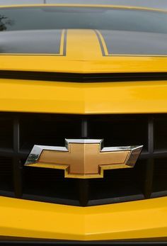 the front end of a yellow chevrolet car