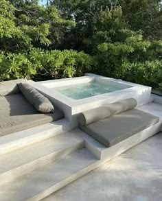 an outdoor jacuzzi with cushions and pillows on it