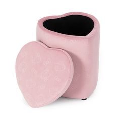 a pink heart shaped trash can sitting on top of a white floor