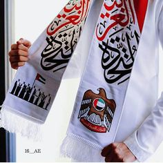 a man wearing a white shirt and red tie with an eagle on it's neck