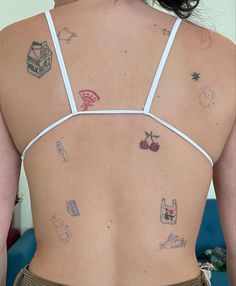 the back of a woman's bra with tattoos on her left side and chest