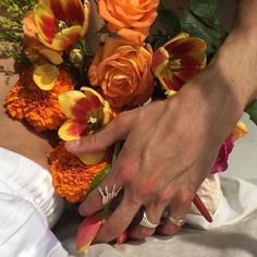 a person is holding flowers in their hands