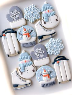 decorated cookies in the shape of snowmen and ice skates with words let it snow