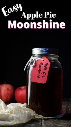 an apple pie is in a mason jar with a red tag on it and the words easy apple pie moonshine