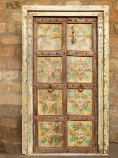 an old wooden door with flowers painted on it