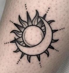 a sun and moon tattoo on the leg