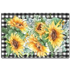 sunflowers and leaves on a black and white checkered tablecloth