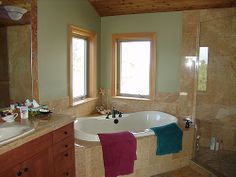 a bathroom with two sinks and a large bathtub in it's center area