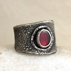 "Garnet silver ring. Dimensions: -stone 0.6 - 0.7 cm, 0.24 - 0.28\" -band width 0.9 - 1.7 cm, 0.35 - 0.67\" -size adjustable (please write me your size, I'll set it)." Silver Hand Forged Wide Band Open Ring, Sterling Silver Wide Band Ring With Oxidized Finish, Silver Byzantine Gemstone Jewelry, Medieval Style Silver Promise Ring, Star Garnet, Garnet Gem, Geometric Ring, Red Band, Ring Photos