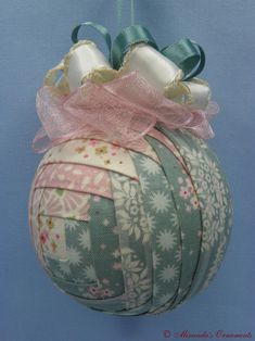 an ornament hanging from a string on a blue background