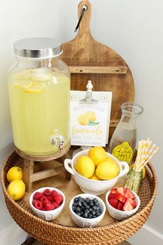 a tray with lemons, strawberries, blueberries and raspberries on it