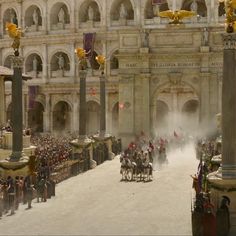 a group of men riding horses down a street next to a tall building with columns