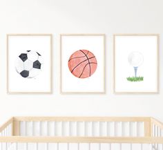 three framed sports pictures on the wall above a crib