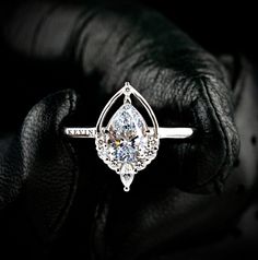 a diamond ring sitting on top of a glove