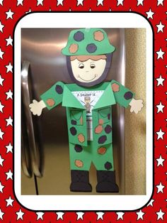 a paper cut out of a man in pajamas and hat standing next to a refrigerator