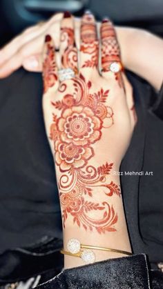 a woman's hand with henna on it