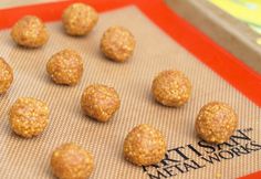 there are many balls of food on the baking sheet ready to be baked in the oven