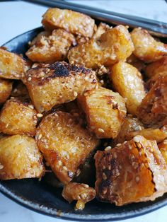 fried food in a bowl with chopsticks on the side