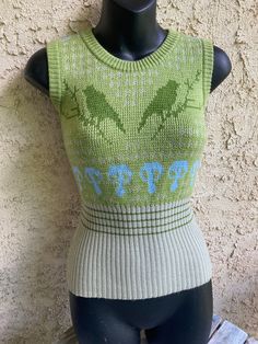 Vintage Judi Rosen New York Form Fitting Sweater Vest with Bird & Mushrooms Motif Size Women's Large Measures Length 22.5"  Armpit to armpit 16" This sweater has some stretch for a form fit/sleek look. Judi Rosen is a renowned denim designer who founded her brand and store in 1992. Her current store has been a fixture in Nolita since 2019. Her designs have been worn by everyone from Britney Spears, Mary J. Blige to the everyday people who have supported her dreams since day one.  "I put New York Vintage Green Knit Tops, 90s Green Winter Sweater, Vintage Green Oversized Sweater, Vintage Jacquard Knit Tops, Vintage Jacquard Knit Winter Sweater, Mary J, Sweater Vest Women, Sleek Look, Britney Spears