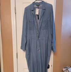 Nwt..Denim Collared Jumpsuit With Buttons And Zippered Mid Section..Can Roll Sleeves Up Or Wear Down Light Weight And Slightly Loose Utility Style Long Sleeve Denim Jumpsuit In Medium Wash, Utility Long Sleeve Medium Wash Denim Jumpsuit, Relaxed Fit Light Wash Jumpsuits And Rompers, Long Sleeve Medium Wash Denim Jumpsuit In Utility Style, Light Wash Denim Long Sleeve Jumpsuit, Medium Wash Relaxed Fit Button-up Jumpsuit, Denim Blue Long Sleeve Jumpsuits And Rompers For Spring, Long Sleeve Denim Blue Cotton Jumpsuit, Denim Blue Long Sleeve Jumpsuits For Spring