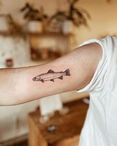 a man with a fish tattoo on his arm