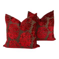 two red and brown pillows sitting next to each other