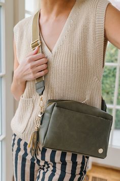 Crafted from luxe vegan leather and complete with glossy gold hardware, the Kara Crossbody is the epitome of elevating your everyday. This spacious bag features special touches that you'll wonder how you ever lived without, like built-in card slots (eliminating the need for a bulky wallet), an adjustable strap (multi-wear options!), and pockets galore (allll the organization). Effortlessly chic and endlessly versatile, the occasions you'll wear this bag for are as infinite as the reasons you'll adore it. Details: 9.5" wide x 6.5" long x 3" deep 2 exterior zippered pockets Front zippered pocket has 4 built-in card slots 1 interior zippered pocket Detachable strap adjusts from 35"-55" 1.5" wide Detachable tassel Gold hardware Vegan leather exterior Light, easy-to-see interior lining Platform Flats, Flying Monkey Jeans, Black Camel, Judy Blue Jeans, Crossbody Wallet, Modern Chic, Glasses Accessories, Cocktail Dress Party, Handbag Accessories