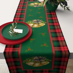 a table topped with a green and red plaid table cloth