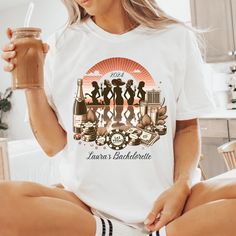 This retro Las Vegas bachelorette Comfort Colors® shirt, features a vintage design with poker chips, money, and silhouettes of ladies sipping champagne, capturing the fun and excitement of a Vegas girls' trip. The bold, vibrant imagery gives off classic Vegas, perfect for a bride's last fling or a bachelorette party.  SIZE UP FOR OVERSIZED LOOK! Because these are print on order shirts we do not accept returns of exchanges. If there is a problem with your order, please let us know right away, and Wedding Merch, Retro Las Vegas, Classic Vegas, Sipping Champagne, Retro Vacation, Vegas Girls Trip, Luxury Bachelorette, Las Vegas Bachelorette, Vegas Bachelorette