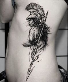 a woman's stomach with an arrow tattoo on it