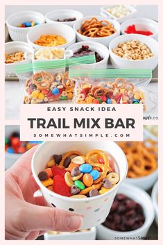 a person holding up a small bowl filled with trail mix bar cereals and pretzels