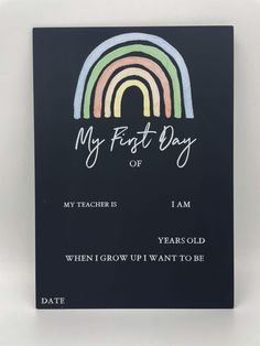 a card with the words, my first day on it and an image of a rainbow