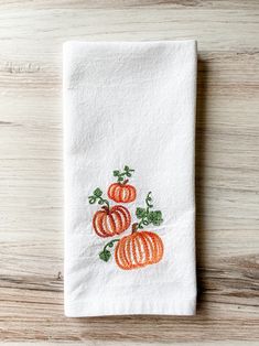 an embroidered dish towel with tomatoes on it