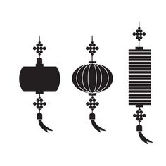 three chinese lanterns hanging from the ceiling, one with a long tail and one with an arrow