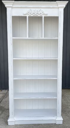 an old white bookcase painted with chalk paint