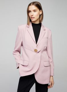 The Ruthie pink blazer stands out with it's asymmetrical design and faux gold button detail which adds a touch of luxury. This  sharp, edgy pink blazer is a game changer. It can be worn closed or open for a more relaxed look Relaxed feminine Silhouette. Asymmetrical. Gold button detail. Side Pockets with Flaps. Long Sleeves with Buttons. Lined Blazer Rose, How To Wear Blazers, Work Blazer, Ribbed Tank Top, Feminine Silhouette, Pink Blazer, Womens Blazers, Ribbed Tank Tops, Casual Blazer