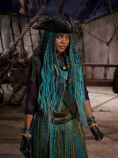 a woman with long blue hair and dreadlocks on her head is standing in front of a ship